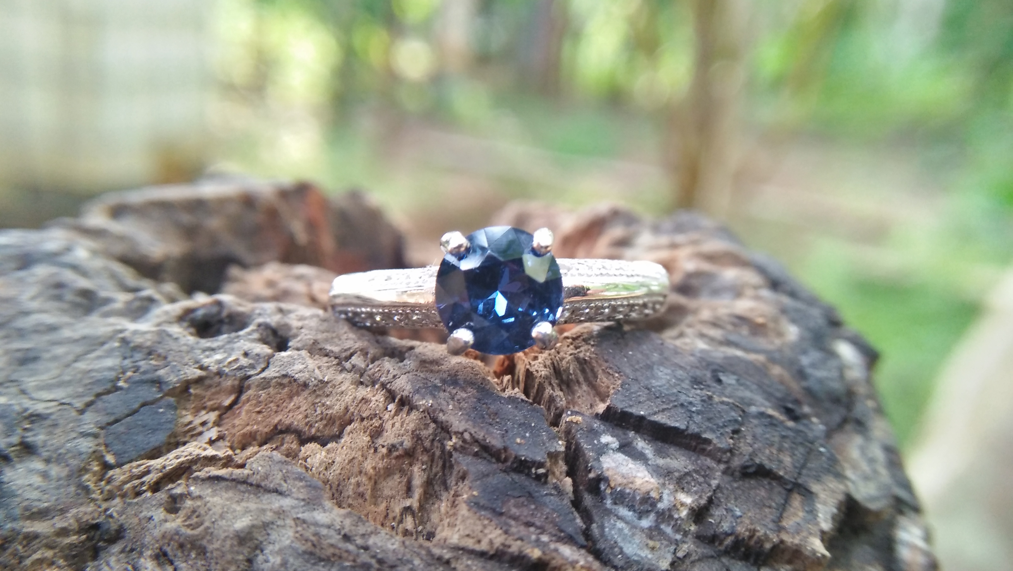 Natural Blue Spinel Standard 925 Silver Ring Stone : Natuarl Blue Sapinel Shape : Round Brilliant Cut ( Diamond Cut) Clarity : Clean Treatment : Natural/Unheated Dimension : 6.1 mm x 3.1mm Mineral : City of gem Ratnapura Sri Lanka Metal : Standard 925 Silver Other : Also, We attached 24 AD's (American Diamond) to get more luster & More Beauty.