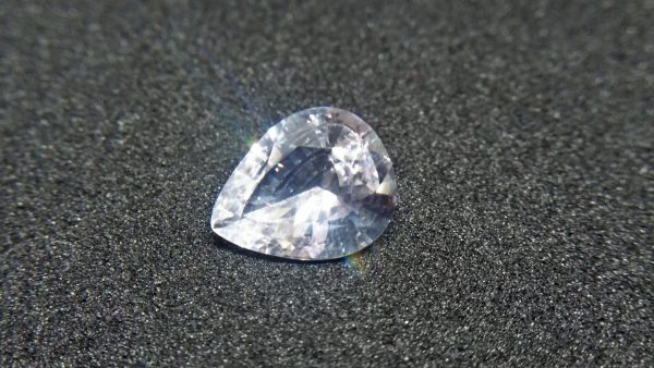 Ceylon White Sapphire Weight : 2.45Cts Dimension : 10.3 mm x 8.4 mm x 4.2 mm Color : White Treatment : Heated Transparent: Good Transparency Shape : Pear Clarity : VS Danu Group - Gemstones Directly from the Source COLORED STONE LABORATORY CERTIFIED ( GIA Alumni Association Member) CSL Memo NO : 166CD6D4BD14 Sapphire is a precious gemstone, a variety of the mineral corundum, consisting of aluminum oxide with trace amounts of elements such as iron, titanium, chromium, copper, or magnesium. Sapphire deposits are found in Eastern Australia, Thailand, Sri Lanka, China, Vietnam, Madagascar, Greenland, East Africa, and in North America in mostly in Montana. Madagascar, Sri Lanka, and Kashmir produce large quantities of fine quality Sapphires for the world market. Sapphires are mined from alluvial deposits or from primary underground workings. Blue Sapphire and Ruby are the most popular Gemstone in Corundum Family. also, Orangy Pink Sapphire is called Padparadscha. The name Drive's from the Sinhalese word "padmaraga" " පද්මරාග", meaning lotus blossom, as the stone is of a similar color to the lotus blossom. Bi-Color Sapphire from DanuGroup Collection Also, Sapphire can be found as parti-color, bi-color or fancy color. Australia is a main parti-color Sapphire producer. White Sapphire also, White sapphire is a very popular stone to wear instead of Diamond as a 3rd hardness gemstone after diamond ( moissanite hardness is 9.5). Various colors of star sapphires A star sapphire is a type of sapphire that exhibits a star-like phenomenon known as asterism. Also, A rare variety of natural sapphire, known as color-change sapphire, exhibits different colors in a different light. Sapphires can be treated by several methods to enhance and improve their clarity and color. A common method is done by heating the sapphires in furnaces to temperatures between 500 and 1,850 °C for several hours, or by heating in a nitrogen-deficient atmosphere oven for 1 week or more. Geuda is a form of the mineral corundum. Geuda is found primarily in Sri Lanka. It's a semitransparent and milky appearance due to rutile inclusions. Geuda is used to improve its color by heat treatment. Some geuda varieties turn to a blue color after heat treatments and some turn to red after oxidizing. Also, Kowangu pushparaga turns to yellow sapphire after oxidizing. Sapphire Crystal system is a Trigonal crystal system with a hexagonal scalenohedral crystal class. Sapphire hardness is 9 according to the Mohs hardness scale with 4.0~4.1 specific gravity. Refractive index ω          =1.768–1.772 nε =1.760–1.763 Solubility = Insoluble Melting point = 2,030–2,050 °C Birefringence  = 0.008 Pleochroism = Strong Luster = Vitreous Sapphire is the birthstone for September and the gem of the 45th anniversary. Healing Properties of Sapphire Sapphire releases mental tension, depression, unwanted thoughts, and spiritual confusion.  Sapphire is known as a "stone of Wisdom". It is exceptional for calming and focusing the mind, allowing the release of mental tension and unwanted thoughts. Sapphire is also the best stone for awakening chakras. Dark Blue or Indigo Sapphire stimulates the Third Eye chakra. Blue Sapphire stimulates the Throat Chakra. Green sapphire stimulates Heart Chakra. Black Sapphire stimulates Base Chakra. White sapphire stimulates Crown Chakra. Yellow sapphire stimulates Solar Plexus Chakra. White Sapphire brings wisdom and strength of spirit. It stimulates the pineal and pituitary glands and also beneficial in gathering courage. White Sapphire stimulates the Crown Chakra. It helps to balance crown chakra to balance your energies. When crown chakra balance, energies are balance. As a pure Aluminium Oxide crystal, White Sapphire clears the mind during meditation. Its vibrant energies help to reduce stress and keep calm your mind during meditation.