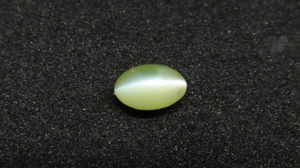 Chrysoberyl Cats Eye Colour : Greenish Yellow Shape : Oval Cut : Cabochon Weight : 1.04 Cts Dimension : 6.5 x 4.1 x 4.1 mm Treatment : Unheated Clarity : Clean • CSL - Colored Stone Laboratory Certified ( GIA Alumni Association Member ) • CSL Memo No : 96FCB5F4103D V The Gemstone Chrysoberyl is an aluminate of beryllium with the chemical formula BeAl₂O₄. The name chrysoberyl is derived from the Greek words "chrysos" and "beryllos". Its meaning is "a gold-white spar". It is known as a hard and durable gem after Sapphire. Chrysoberyl is an orthorhombic crystal mineral with 3.5 – 3.84 specific gravity and 8.5 hardness according to the more hardness scale. It is a Biaxial (+) mineral with refractive indexes nα=1.745 nβ=1.748 nγ=1.754. Chrysoberyl family Gemstones from old collection Chrysoberyl can be found colors such as green, yellow, brownish to greenish-black, colorless, pale shades of yellow, greenish Yellow, Yellowish Green, Honey Brown, Reddish Brown, Orangy yellow, Greenish Brown, Blue. Also, Golden Yellow Chrysoberyl is called "Ceylonese Chrysolite" as a trading name. Alexandrite Alexandrite cats eye The Chrysoberyl Alexandrite is a color change variety upon the nature of ambient lighting. It changes the color green to brownish red or green to purplish-red in the incandescent light from a lamp or candle flame. However, Alexandrite's good color change stones are extremely rare. also, Chrysoberyl alexandrite can be found with a chatoyancy future. It is rare and expensive. Chrysoberyl crystal from Danu Group Old Collection An interesting feature of its crystals are the cyclic twins called trillings. Alexandrite Crystal Under UV Also, Chrysoberyl can be found with the chatoyancy feature. Translucent yellowish chatoyant chrysoberyl is called as cymophane. Also, Chrysoberyl cat's eye is found in colors such as yellowish-green, green, honey brown, grey. The chrysoberyl gemstone or mineral can be found in Sri Lanka, Afghanistan, India, Madagascar, Tanzania, Ethiopia, Australia, Brazil, Canada, France, Germany, Italy, Japan, Kenya, Kazakhstan, Namibia, Myanmar, Mozambique, Norway, Russia, Spain, USA, Zambia. Healing Properties of Chrysoberyls Chrysoberyl is known as an effective and protective stone since ancient times. It transforms negative thoughts into positive energy. Chrysoberyl gemstone or mineral is associated with wealth and creativity and promotes tolerance and harmony. It stimulates the solar plexus and crown chakras. Chrysoberyl helps to open the crown chakra and increases both spiritual and personal power. Green chrysoberyl stimulates the healing of the physical heart. Chrysoberyl stimulates the cleansing and balancing of the liver, kidneys, gall bladder and balances adrenaline and cholesterol and fortifies the chest and liver. Chrysoberyl Cat's eye increases the vibration of Ketu in the wearer according to Vedic Astrology. It is known to reduce the malefic effects of 'Ketu' and increase its beneficial qualities. Chrysoberyl transforms negative thoughts into positive energy. It supports self-healing. Chrysoberyl balances adrenaline and cholesterol and fortifies the chest and liver.
