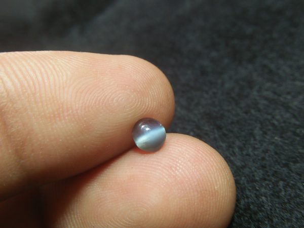 Natural Alexandrite Cats Eye Colour : c.c from Deep Green to deep red Shape : Round Cut : Cabochon Weight : 0.44 Cts Dimension : 4.8 x 4.3 x 2.2 mm Treatment : Unheated