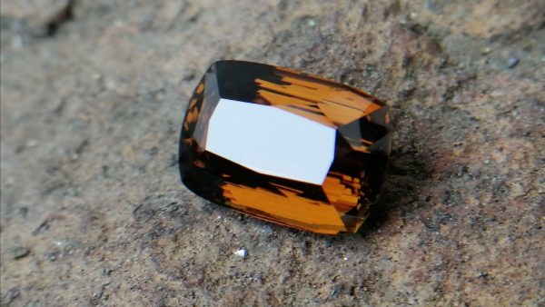 Colour : Brown Shape : Cushion Weight : 5.43 Cts Dimension : 12.4 x 8.5 x 6.3 mm Treatment : Unheated Clarity: VVS • CSL - Colored Stone Laboratory Certified ( GIA Alumni Association Member ) • CSL Memo No : 693F81AA1E41 Dravite Tourmaline Sri Lanka Dravite is the sodium magnesium rich Variety in the tourmaline family. Tourmaline is a crystalline boron silicate mineral compounded with elements such as aluminium, iron, magnesium, sodium, lithium, or potassium.                            The gemstone comes in a wide variety of colors such as black, brown, red, orange, yellow, green, blue, violet, pink, bi-colored, tri-colored and rarely can be neon green or electric blue.                               Tourmaline pleochroism is typically moderate to Strong. It is Cyclosilicate mineral with 7-7.5 hardness according to the more hardness scale and 3.06 (+.20 -.06) specific gravity. It is a Double refractive, uniaxial (-) mineral with the Trigonal crystal system. Tourmaline can be seen fluorescent inert to very weak red to violet in the long and short wave in pink Stones.                  Tourmaline can be found in India, Brazil, Tanzania, Nigeria, Kenya, Madagascar, Mozambique, Namibia, Afghanistan, Sri Lanka, USA, Ethiopia. Tourmaline Healing Properties              Tourmaline balances the right-left sides of the brain. It Helps treat paranoia, overcomes dyslexia. Also, It Improves circulation and supports the liver and kidneys.                            Tourmaline helps to eliminate toxic metals in the body and Reduces lactic acids and free fatty acids. It is a stone of purification, cleansing the emotional body of negative thoughts, anxieties, anger, and feelings of unworthiness.                         The brown tourmaline brings gentle and soothing healing of your emotional body. It is a very strong grounding stone that raises one’s stamina and protective energies. Brown tourmaline works specifically with the heart chakra to provide self-healing and rejuvenating energies.