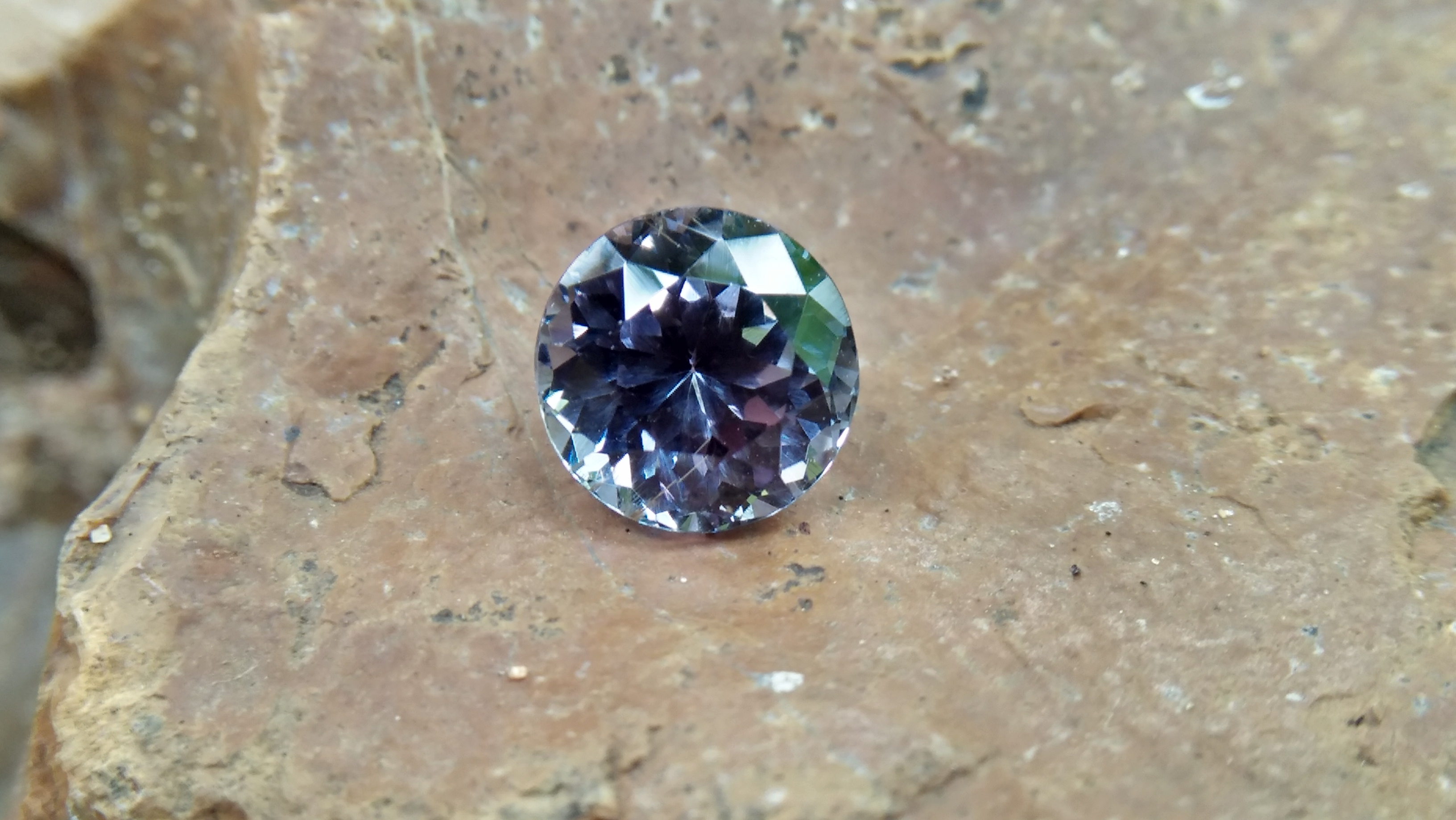 Natural Violetish Gray Spinel Shape : Round Cut : Round Flower Cut Clarity : SI Treatment : Natural/Unheated Dimension : 7.25 mm x 5.3 mm Weight : 2.05Cts Location : City of Gem Ratnapura Sri Lanka