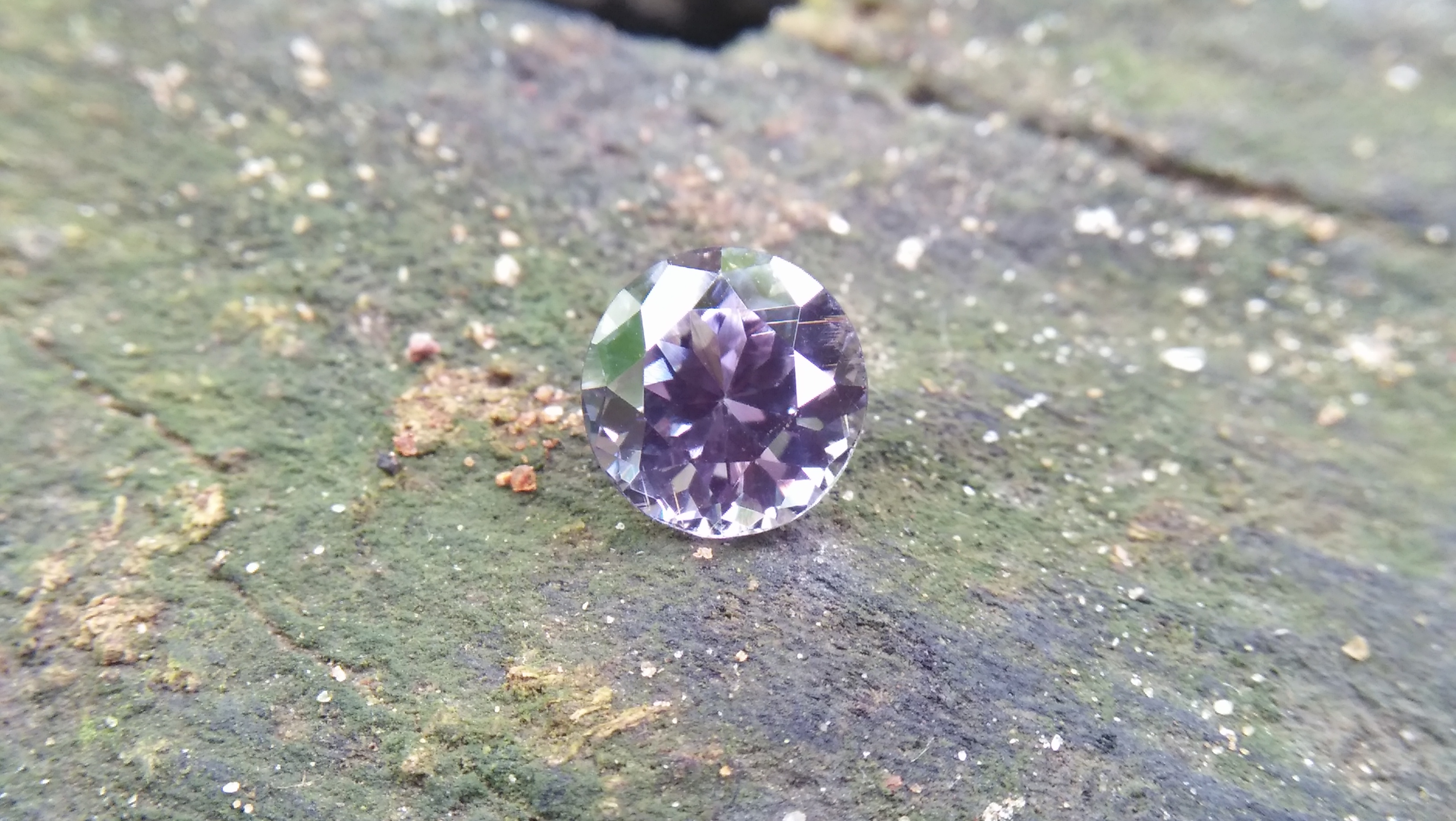 Natural Violetish Gray Spinel Shape : Round Cut : Round Flower Cut Clarity : SI Treatment : Natural/Unheated Dimension : 7.25 mm x 5.3 mm Weight : 2.05Cts Location : City of Gem Ratnapura Sri Lanka