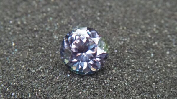 Natural Violetish Gray Spinel Shape : Round Cut : Round Flower Cut Clarity : SI Treatment : Natural/Unheated Dimension : 7.25 mm x 5.3 mm Weight : 2.05Cts Location : City of Gem Ratnapura Sri Lanka