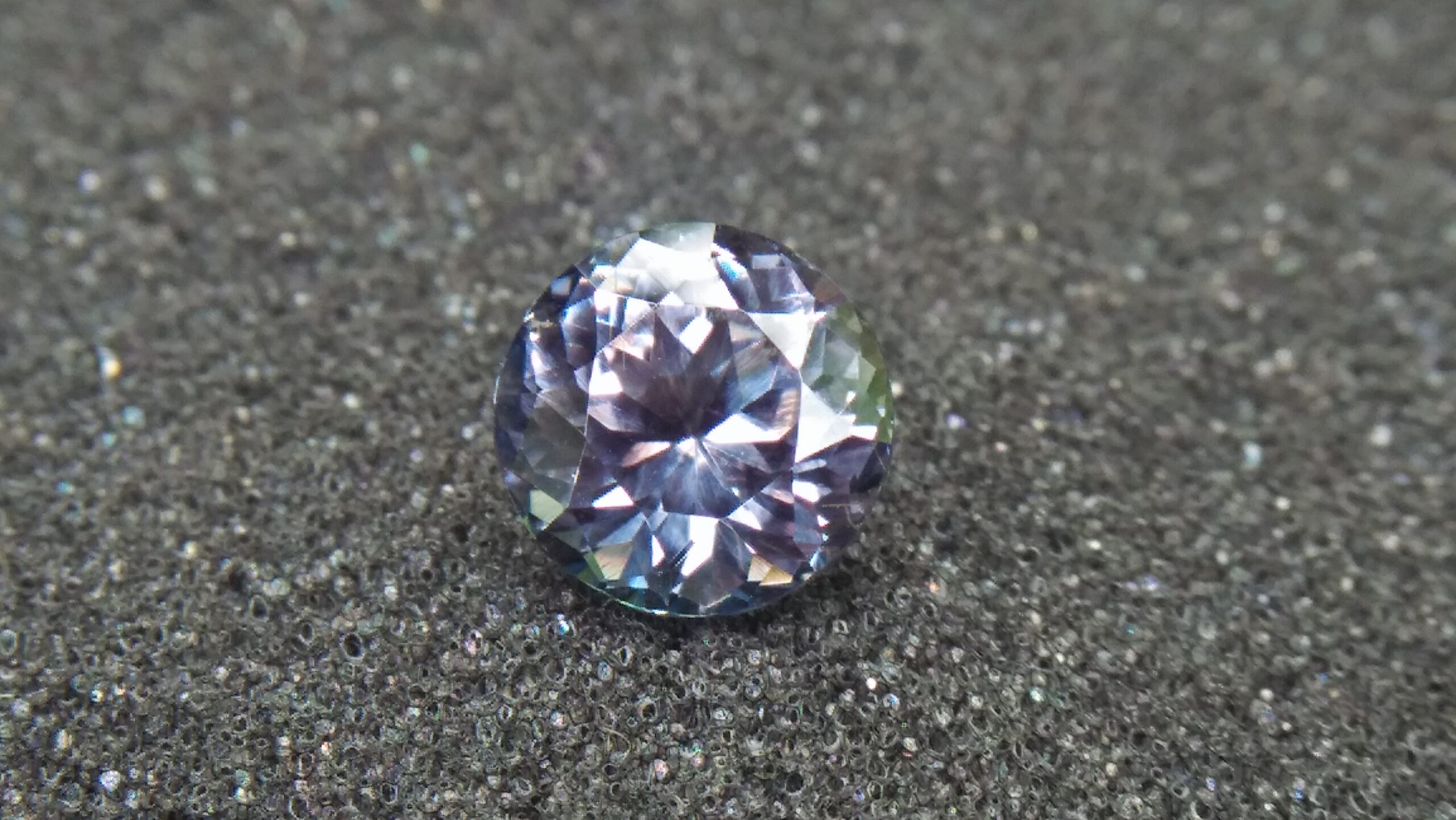 Natural Violetish Gray Spinel Shape : Round Cut : Round Flower Cut Clarity : SI Treatment : Natural/Unheated Dimension : 7.25 mm x 5.3 mm Weight : 2.05Cts Location : City of Gem Ratnapura Sri Lanka