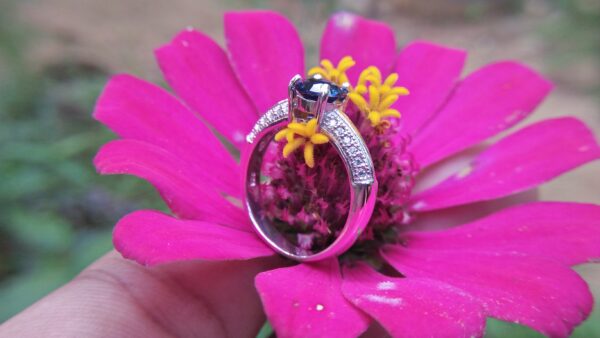 Natural Blue Spinel Standard 925 Silver Ring Stone : Natuarl Blue Sapinel Shape : Round Brilliant Cut ( Diamond Cut) Clarity : Clean Treatment : Natural/Unheated Dimension : 6.1 mm x 3.1mm Mineral : City of gem Ratnapura Sri Lanka Metal : Standard 925 Silver Other : Also, We attached 24 AD's (American Diamond) to get more luster & More Beauty.