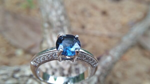 Natural Blue Spinel Standard 925 Silver Ring Stone : Natuarl Blue Sapinel Shape : Round Brilliant Cut ( Diamond Cut) Clarity : Clean Treatment : Natural/Unheated Dimension : 6.1 mm x 3.1mm Mineral : City of gem Ratnapura Sri Lanka Metal : Standard 925 Silver Other : Also, We attached 24 AD's (American Diamond) to get more luster & More Beauty.
