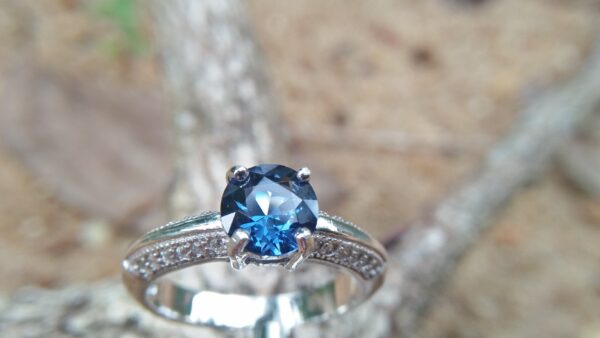 Natural Blue Spinel Standard 925 Silver Ring Stone : Natuarl Blue Sapinel Shape : Round Brilliant Cut ( Diamond Cut) Clarity : Clean Treatment : Natural/Unheated Dimension : 6.1 mm x 3.1mm Mineral : City of gem Ratnapura Sri Lanka Metal : Standard 925 Silver Other : Also, We attached 24 AD's (American Diamond) to get more luster & More Beauty.
