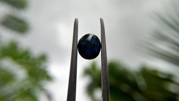 Ceylon Natural Dark Blue Sapphire ( Kakanil ) කාකනිල් සෙනසුරු ග්‍රහයාට අයත් මැණික Shape : Ovel Clarity : Clean Treatment : Natural/Unheated Dimension : 6.3mmx 5.4mm x 3.3mm Weight : 1.09Cts Location : City of Gem Ratnapura Sri Lanka