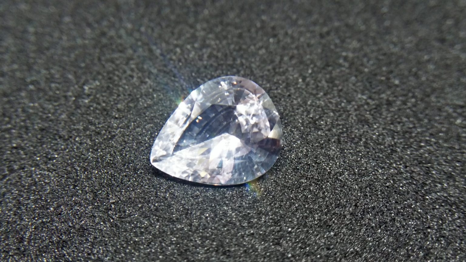 Ceylon White Sapphire Weight : 2.45Cts Dimension : 10.3 mm x 8.4 mm x 4.2 mm Color : White Treatment : Heated Transparent: Good Transparency Shape : Pear Clarity : VS Danu Group - Gemstones Directly from the Source COLORED STONE LABORATORY CERTIFIED ( GIA Alumni Association Member) CSL Memo NO : 166CD6D4BD14 Sapphire is a precious gemstone, a variety of the mineral corundum, consisting of aluminum oxide with trace amounts of elements such as iron, titanium, chromium, copper, or magnesium. Sapphire deposits are found in Eastern Australia, Thailand, Sri Lanka, China, Vietnam, Madagascar, Greenland, East Africa, and in North America in mostly in Montana. Madagascar, Sri Lanka, and Kashmir produce large quantities of fine quality Sapphires for the world market. Sapphires are mined from alluvial deposits or from primary underground workings. Blue Sapphire and Ruby are the most popular Gemstone in Corundum Family. also, Orangy Pink Sapphire is called Padparadscha. The name Drive's from the Sinhalese word "padmaraga" " පද්මරාග", meaning lotus blossom, as the stone is of a similar color to the lotus blossom. Bi-Color Sapphire from DanuGroup Collection Also, Sapphire can be found as parti-color, bi-color or fancy color. Australia is a main parti-color Sapphire producer. White Sapphire also, White sapphire is a very popular stone to wear instead of Diamond as a 3rd hardness gemstone after diamond ( moissanite hardness is 9.5). Various colors of star sapphires A star sapphire is a type of sapphire that exhibits a star-like phenomenon known as asterism. Also, A rare variety of natural sapphire, known as color-change sapphire, exhibits different colors in a different light. Sapphires can be treated by several methods to enhance and improve their clarity and color. A common method is done by heating the sapphires in furnaces to temperatures between 500 and 1,850 °C for several hours, or by heating in a nitrogen-deficient atmosphere oven for 1 week or more. Geuda is a form of the mineral corundum. Geuda is found primarily in Sri Lanka. It's a semitransparent and milky appearance due to rutile inclusions. Geuda is used to improve its color by heat treatment. Some geuda varieties turn to a blue color after heat treatments and some turn to red after oxidizing. Also, Kowangu pushparaga turns to yellow sapphire after oxidizing. Sapphire Crystal system is a Trigonal crystal system with a hexagonal scalenohedral crystal class. Sapphire hardness is 9 according to the Mohs hardness scale with 4.0~4.1 specific gravity. Refractive index ω =1.768–1.772 nε =1.760–1.763 Solubility = Insoluble Melting point = 2,030–2,050 °C Birefringence = 0.008 Pleochroism = Strong Luster = Vitreous Sapphire is the birthstone for September and the gem of the 45th anniversary. Healing Properties of Sapphire Sapphire releases mental tension, depression, unwanted thoughts, and spiritual confusion. Sapphire is known as a "stone of Wisdom". It is exceptional for calming and focusing the mind, allowing the release of mental tension and unwanted thoughts. Sapphire is also the best stone for awakening chakras. Dark Blue or Indigo Sapphire stimulates the Third Eye chakra. Blue Sapphire stimulates the Throat Chakra. Green sapphire stimulates Heart Chakra. Black Sapphire stimulates Base Chakra. White sapphire stimulates Crown Chakra. Yellow sapphire stimulates Solar Plexus Chakra. White Sapphire brings wisdom and strength of spirit. It stimulates the pineal and pituitary glands and also beneficial in gathering courage. White Sapphire stimulates the Crown Chakra. It helps to balance crown chakra to balance your energies. When crown chakra balance, energies are balance. As a pure Aluminium Oxide crystal, White Sapphire clears the mind during meditation. Its vibrant energies help to reduce stress and keep calm your mind during meditation.