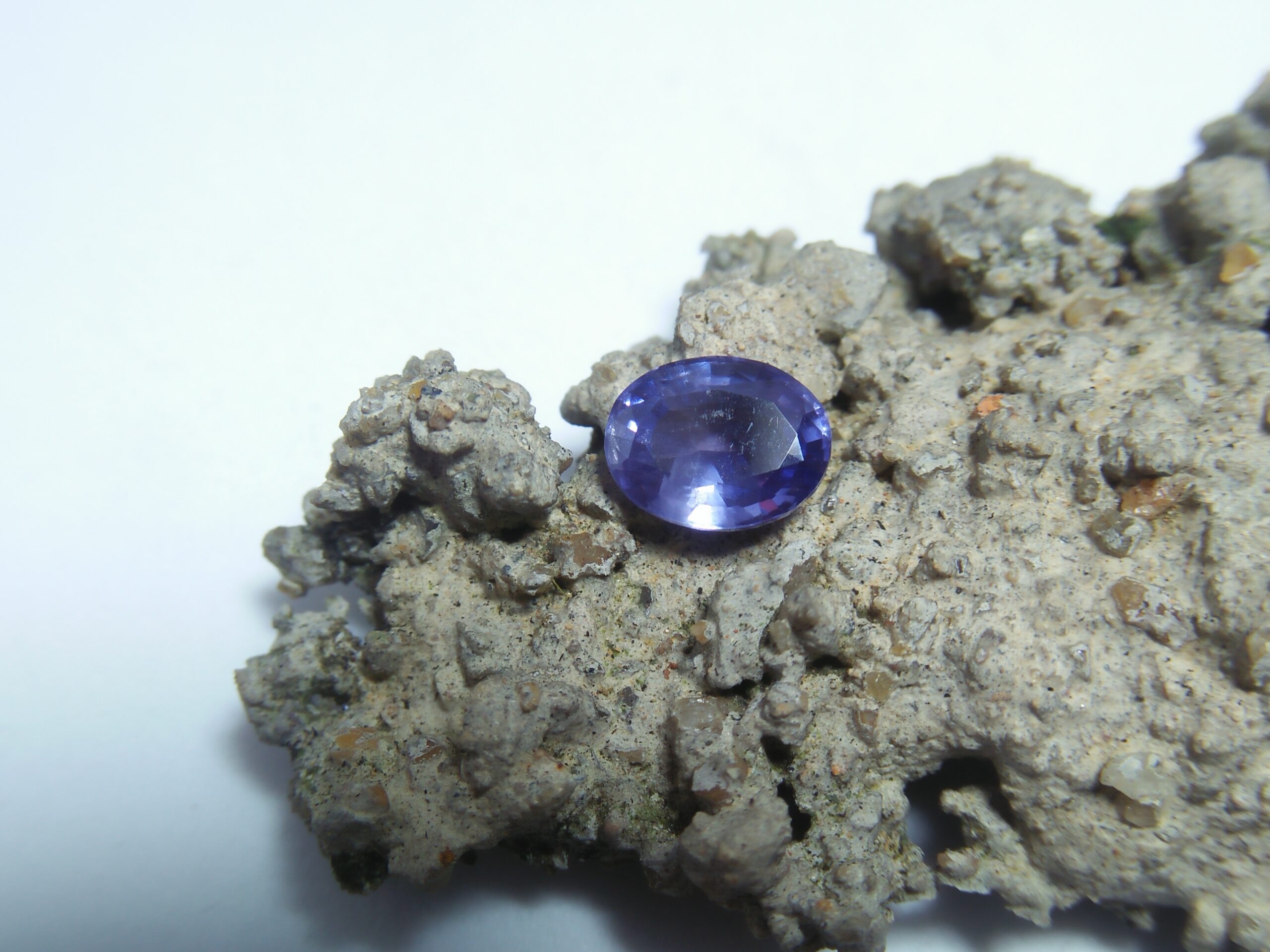 Ceylon Natural Blue Sapphire Colour : Blue Shape : Oval Weight : 1.65 ct Dimension : 7.7mm x 6.2mm x 3.8 mm Treatment : Unheated/ Natural • CSL - Colored Stone Laboratory Certified ( GIA Alumina Association Member ) • CSL Memo No : 6DC22456E105 Sapphire is a precious gemstone, a variety of the mineral corundum, consisting of aluminum oxide with trace amounts of elements such as iron, titanium, chromium, copper, or magnesium. Sapphire deposits are found in Eastern Australia, Thailand, Sri Lanka, China, Vietnam, Madagascar, Greenland, East Africa, and in North America in mostly in Montana. Madagascar, Sri Lanka, and Kashmir produce large quantities of fine quality Sapphires for the world market. Sapphires are mined from alluvial deposits or from primary underground workings. Blue Sapphire and Ruby are the most popular Gemstone in Corundum Family. also, Orangy Pink Sapphire is called Padparadscha. The name Drive's from the Sinhalese word "padmaraga" " පද්මරාග", meaning lotus blossom, as the stone is of a similar color to the lotus blossom. Bi-Color Sapphire from DanuGroup Collection Also, Sapphire can be found as parti-color, bi-color or fancy color. Australia is a main parti-color Sapphire producer. White Sapphire also, White sapphire is a very popular stone to wear instead of Diamond as a 3rd hardness gemstone after diamond ( moissanite hardness is 9.5). Various colors of star sapphires A star sapphire is a type of sapphire that exhibits a star-like phenomenon known as asterism. Also, A rare variety of natural sapphire, known as color-change sapphire, exhibits different colors in a different light. Sapphires can be treated by several methods to enhance and improve their clarity and color. A common method is done by heating the sapphires in furnaces to temperatures between 500 and 1,850 °C for several hours, or by heating in a nitrogen-deficient atmosphere oven for 1 week or more. Geuda is a form of the mineral corundum. Geuda is found primarily in Sri Lanka. It's a semitransparent and milky appearance due to rutile inclusions. Geuda is used to improve its color by heat treatment. Some geuda varieties turn to a blue color after heat treatments and some turn to red after oxidizing. Also, Kowangu pushparaga turns to yellow sapphire after oxidizing. Sapphire Crystal system is a Trigonal crystal system with a hexagonal scalenohedral crystal class. Sapphire hardness is 9 according to the Mohs hardness scale with 4.0~4.1 specific gravity. Refractive index ω =1.768–1.772 nε =1.760–1.763 Solubility = Insoluble Melting point = 2,030–2,050 °C Birefringence = 0.008 Pleochroism = Strong Luster = Vitreous Sapphire is the birthstone for September and the gem of the 45th anniversary. Healing Properties of Sapphire Sapphire releases mental tension, depression, unwanted thoughts, and spiritual confusion. Sapphire is known as a "stone of Wisdom". It is exceptional for calming and focusing the mind, allowing the release of mental tension and unwanted thoughts. Sapphire is also the best stone for awakening chakras. Dark Blue or Indigo Sapphire stimulates the Third Eye chakra. Blue Sapphire stimulates the Throat Chakra. Green sapphire stimulates Heart Chakra. Black Sapphire stimulates Base Chakra. White sapphire stimulates Crown Chakra. Yellow sapphire stimulates Solar Plexus Chakra. Blue Sapphire stimulates the Throat Chakra and Third eye chakra, the voice of the body. Blue crystal energy will unblock and balance the Throat Chakra. blue encourages the power of truth, while lighter shades carry the power of flexibility, relaxation, and balance. Blue Sapphire can free one of mental anxiety, helps make one detached, and protects against envy. Also, It can be worn for good luck and for protection against evil spirits. Since Saturn rules the nervous system, blue sapphires help problems of the nerves-tension and neuroses-diseases caused by an afflicted Saturn.