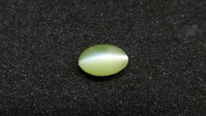 Chrysoberyl Cats Eye Colour : Greenish Yellow Shape : Oval Cut : Cabochon Weight : 1.04 Cts Dimension : 6.5 x 4.1 x 4.1 mm Treatment : Unheated Clarity : Clean • CSL - Colored Stone Laboratory Certified ( GIA Alumina Association Member ) • CSL Memo No : 96FCB5F4103D V The Gemstone Chrysoberyl is an aluminate of beryllium with the chemical formula BeAl₂O₄. The name chrysoberyl is derived from the Greek words "chrysos" and "beryllos". Its meaning is "a gold-white spar". It is known as a hard and durable gem after Sapphire. Chrysoberyl is an orthorhombic crystal mineral with 3.5 – 3.84 specific gravity and 8.5 hardness according to the more hardness scale. It is a Biaxial (+) mineral with refractive indexes nα=1.745 nβ=1.748 nγ=1.754. Chrysoberyl family Gemstones from old collection Chrysoberyl can be found colors such as green, yellow, brownish to greenish-black, colorless, pale shades of yellow, greenish Yellow, Yellowish Green, Honey Brown, Reddish Brown, Orangy yellow, Greenish Brown, Blue. Also, Golden Yellow Chrysoberyl is called "Ceylonese Chrysolite" as a trading name. Alexandrite Alexandrite cats eye The Chrysoberyl Alexandrite is a color change variety upon the nature of ambient lighting. It changes the color green to brownish red or green to purplish-red in the incandescent light from a lamp or candle flame. However, Alexandrite's good color change stones are extremely rare. also, Chrysoberyl alexandrite can be found with a chatoyancy future. It is rare and expensive. Chrysoberyl crystal from Danu Group Old Collection An interesting feature of its crystals are the cyclic twins called trillings. Alexandrite Crystal Under UV Also, Chrysoberyl can be found with the chatoyancy feature. Translucent yellowish chatoyant chrysoberyl is called as cymophane. Also, Chrysoberyl cat's eye is found in colors such as yellowish-green, green, honey brown, grey. The chrysoberyl gemstone or mineral can be found in Sri Lanka, Afghanistan, India, Madagascar, Tanzania, Ethiopia, Australia, Brazil, Canada, France, Germany, Italy, Japan, Kenya, Kazakhstan, Namibia, Myanmar, Mozambique, Norway, Russia, Spain, USA, Zambia. Healing Properties of Chrysoberyls Chrysoberyl is known as an effective and protective stone since ancient times. It transforms negative thoughts into positive energy. Chrysoberyl gemstone or mineral is associated with wealth and creativity and promotes tolerance and harmony. It stimulates the solar plexus and crown chakras. Chrysoberyl helps to open the crown chakra and increases both spiritual and personal power. Green chrysoberyl stimulates the healing of the physical heart. Chrysoberyl stimulates the cleansing and balancing of the liver, kidneys, gall bladder and balances adrenaline and cholesterol and fortifies the chest and liver. Chrysoberyl Cat's eye increases the vibration of Ketu in the wearer according to Vedic Astrology. It is known to reduce the malefic effects of 'Ketu' and increase its beneficial qualities. Chrysoberyl transforms negative thoughts into positive energy. It supports self-healing. Chrysoberyl balances adrenaline and cholesterol and fortifies the chest and liver.