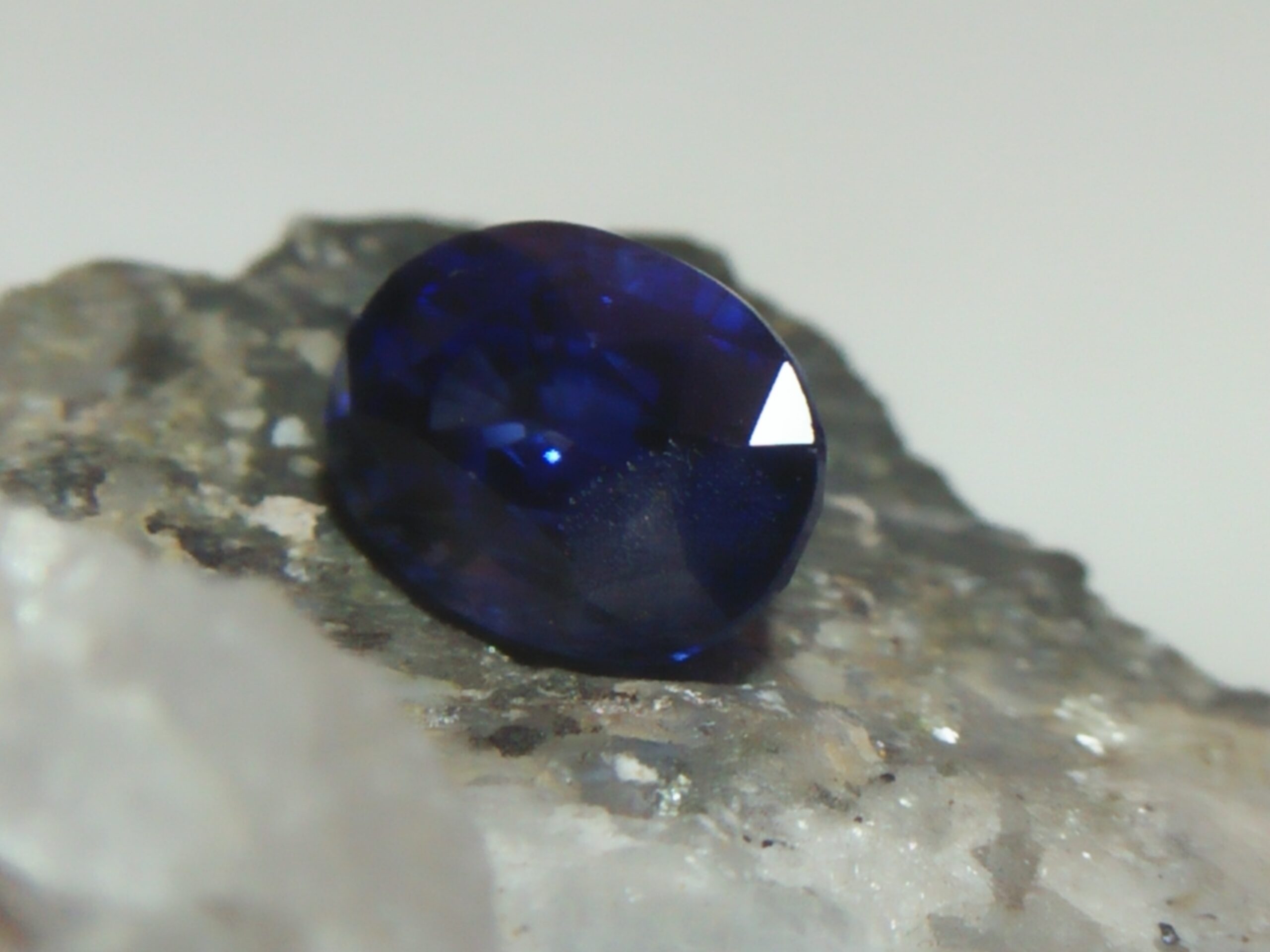 NATURAL BLUE SAPPHIRE Colour : Vivid Blue "Royal Blue" Shape : Oval Weight : 2.16 CTS Dimension : 8.4 x 6.1 x 4.9 mm Treatments : Heated Clarity : SI • CSL - Colored Stone Laboratory Certified ( GIA Alumina Association Member ) • CSL Memo No : E63051265A61 Sapphire is a precious gemstone, a variety of the mineral corundum, consisting of aluminum oxide with trace amounts of elements such as iron, titanium, chromium, copper, or magnesium. Sapphire deposits are found in Eastern Australia, Thailand, Sri Lanka, China, Vietnam, Madagascar, Greenland, East Africa, and in North America in mostly in Montana. Madagascar, Sri Lanka, and Kashmir produce large quantities of fine quality Sapphires for the world market. Sapphires are mined from alluvial deposits or from primary underground workings. Blue Sapphire and Ruby are the most popular Gemstone in Corundum Family. also, Orangy Pink Sapphire is called Padparadscha. The name Drive's from the Sinhalese word "padmaraga" " පද්මරාග", meaning lotus blossom, as the stone is of a similar color to the lotus blossom. Bi-Color Sapphire from DanuGroup Collection Also, Sapphire can be found as parti-color, bi-color or fancy color. Australia is a main parti-color Sapphire producer. White Sapphire also, White sapphire is a very popular stone to wear instead of Diamond as a 3rd hardness gemstone after diamond ( moissanite hardness is 9.5). Various colors of star sapphires A star sapphire is a type of sapphire that exhibits a star-like phenomenon known as asterism. Also, A rare variety of natural sapphire, known as color-change sapphire, exhibits different colors in a different light. Sapphires can be treated by several methods to enhance and improve their clarity and color. A common method is done by heating the sapphires in furnaces to temperatures between 500 and 1,850 °C for several hours, or by heating in a nitrogen-deficient atmosphere oven for 1 week or more. Geuda is a form of the mineral corundum. Geuda is found primarily in Sri Lanka. It's a semitransparent and milky appearance due to rutile inclusions. Geuda is used to improve its color by heat treatment. Some geuda varieties turn to a blue color after heat treatments and some turn to red after oxidizing. Also, Kowangu pushparaga turns to yellow sapphire after oxidizing. Sapphire Crystal system is a Trigonal crystal system with a hexagonal scalenohedral crystal class. Sapphire hardness is 9 according to the Mohs hardness scale with 4.0~4.1 specific gravity. Refractive index ω          =1.768–1.772 nε =1.760–1.763 Solubility = Insoluble Melting point = 2,030–2,050 °C Birefringence  = 0.008 Pleochroism = Strong Luster = Vitreous Sapphire is the birthstone for September and the gem of the 45th anniversary. Healing Properties of Sapphire Sapphire releases mental tension, depression, unwanted thoughts, and spiritual confusion.  Sapphire is known as a "stone of Wisdom". It is exceptional for calming and focusing the mind, allowing the release of mental tension and unwanted thoughts. Sapphire is also the best stone for awakening chakras. Dark Blue or Indigo Sapphire stimulates the Third Eye chakra. Blue Sapphire stimulates the Throat Chakra. Green sapphire stimulates Heart Chakra. Black Sapphire stimulates Base Chakra. White sapphire stimulates Crown Chakra. Yellow sapphire stimulates Solar Plexus Chakra. Blue Sapphire stimulates the Throat Chakra and Third eye chakra, the voice of the body. Blue crystal energy will unblock and balance the Throat Chakra. blue encourages the power of truth, while lighter shades carry the power of flexibility, relaxation, and balance. Blue Sapphire can free one of mental anxiety, helps make one detached, and protects against envy. Also, It can be worn for good luck and for protection against evil spirits. Since Saturn rules the nervous system, blue sapphires help problems of the nerves-tension and neuroses-diseases caused by an afflicted Saturn.