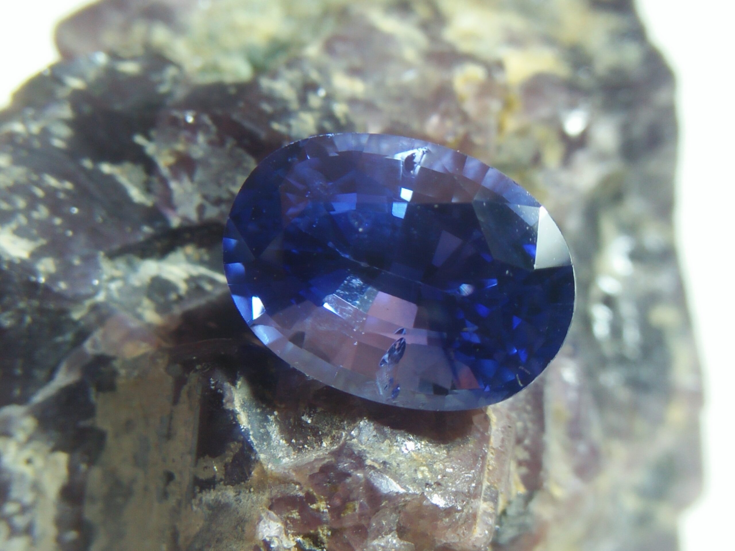 NATURAL BLUE SAPPHIRE "Cornflower Blue' Colour : Blue "Cornflower Blue' Shape : Oval Weight : 2.30 CTS Dimension : 8.6 x 6.3 x 5.3 mm Treatment : Heated Clarity : SI • CSL - Colored Stone Laboratory Certified ( GIA Alumina Association Member ) • CSL Memo No : 8F293B471ADD               Sapphire is a precious gemstone, a variety of the mineral corundum, consisting of aluminum oxide with trace amounts of elements such as iron, titanium, chromium, copper, or magnesium. Sapphire deposits are found in Eastern Australia, Thailand, Sri Lanka, China, Vietnam, Madagascar, Greenland, East Africa, and in North America in mostly in Montana. Madagascar, Sri Lanka, and Kashmir produce large quantities of fine quality Sapphires for the world market. Sapphires are mined from alluvial deposits or from primary underground workings. Blue Sapphire and Ruby are the most popular Gemstone in Corundum Family. also, Orangy Pink Sapphire is called Padparadscha. The name Drive's from the Sinhalese word "padmaraga" " පද්මරාග", meaning lotus blossom, as the stone is of a similar color to the lotus blossom. Bi-Color Sapphire from DanuGroup Collection Also, Sapphire can be found as parti-color, bi-color or fancy color. Australia is a main parti-color Sapphire producer. White Sapphire also, White sapphire is a very popular stone to wear instead of Diamond as a 3rd hardness gemstone after diamond ( moissanite hardness is 9.5). Various colors of star sapphires A star sapphire is a type of sapphire that exhibits a star-like phenomenon known as asterism. Also, A rare variety of natural sapphire, known as color-change sapphire, exhibits different colors in a different light. Sapphires can be treated by several methods to enhance and improve their clarity and color. A common method is done by heating the sapphires in furnaces to temperatures between 500 and 1,850 °C for several hours, or by heating in a nitrogen-deficient atmosphere oven for 1 week or more. Geuda is a form of the mineral corundum. Geuda is found primarily in Sri Lanka. It's a semitransparent and milky appearance due to rutile inclusions. Geuda is used to improve its color by heat treatment. Some geuda varieties turn to a blue color after heat treatments and some turn to red after oxidizing. Also, Kowangu pushparaga turns to yellow sapphire after oxidizing. Sapphire Crystal system is a Trigonal crystal system with a hexagonal scalenohedral crystal class. Sapphire hardness is 9 according to the Mohs hardness scale with 4.0~4.1 specific gravity. Refractive index ω          =1.768–1.772 nε =1.760–1.763 Solubility = Insoluble Melting point = 2,030–2,050 °C Birefringence  = 0.008 Pleochroism = Strong Luster = Vitreous Sapphire is the birthstone for September and the gem of the 45th anniversary. Healing Properties of Sapphire Sapphire releases mental tension, depression, unwanted thoughts, and spiritual confusion.  Sapphire is known as a "stone of Wisdom". It is exceptional for calming and focusing the mind, allowing the release of mental tension and unwanted thoughts. Sapphire is also the best stone for awakening chakras. Dark Blue or Indigo Sapphire stimulates the Third Eye chakra. Blue Sapphire stimulates the Throat Chakra. Green sapphire stimulates Heart Chakra. Black Sapphire stimulates Base Chakra. White sapphire stimulates Crown Chakra. Yellow sapphire stimulates Solar Plexus Chakra. Blue Sapphire stimulates the Throat Chakra and Third eye chakra, the voice of the body. Blue crystal energy will unblock and balance the Throat Chakra. blue encourages the power of truth, while lighter shades carry the power of flexibility, relaxation, and balance. Blue Sapphire can free one of mental anxiety, helps make one detached, and protects against envy. Also, It can be worn for good luck and for protection against evil spirits. Since Saturn rules the nervous system, blue sapphires help problems of the nerves-tension and neuroses-diseases caused by an afflicted Saturn.  