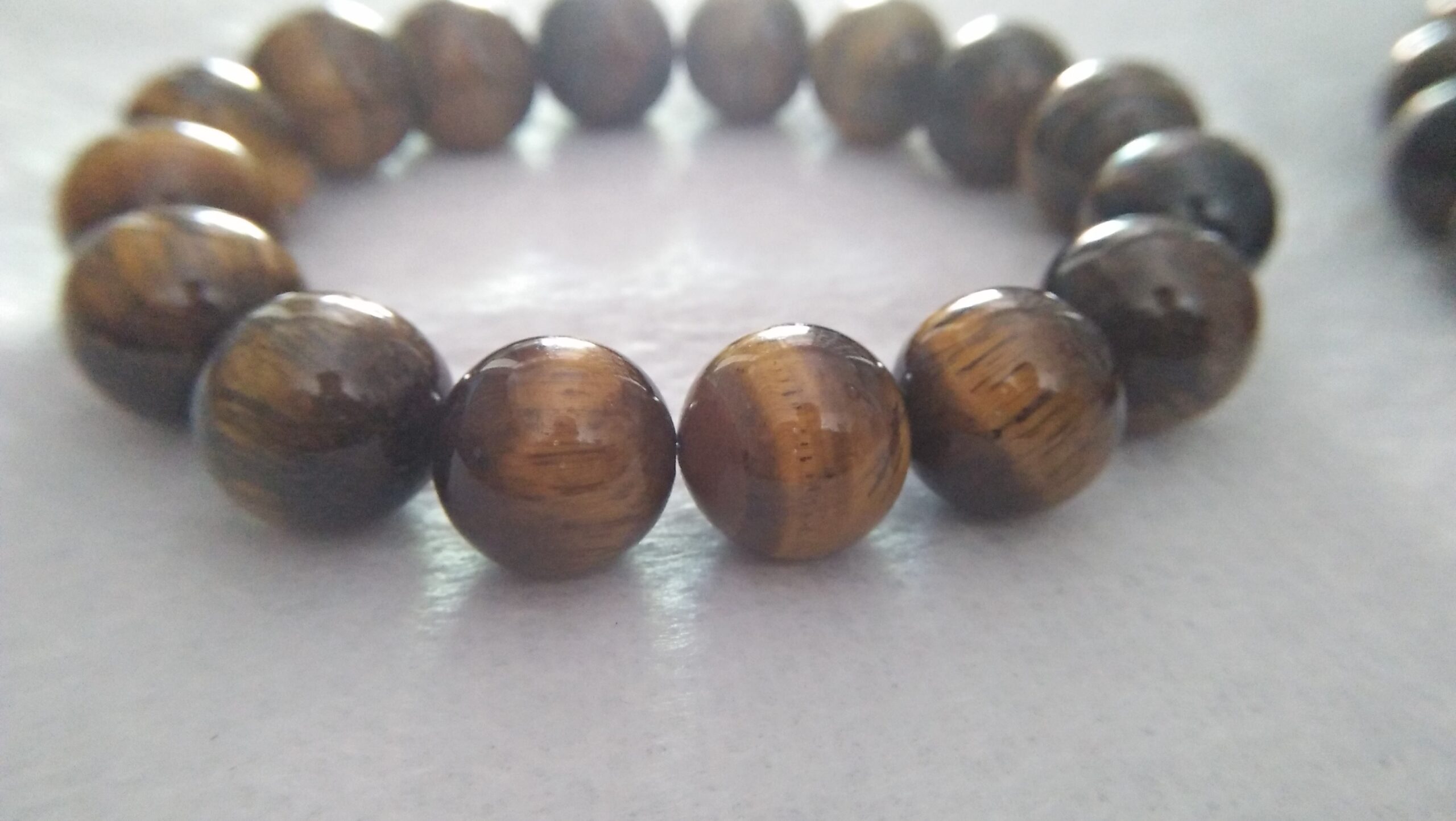 Tiger Eye Bracelet  Stone : Natural Tiger Eye Shape : Round Size : 8.8mm / 10.3mm / 12mm Treatment : Unheated / Natural Design : Gent / Ladies Both