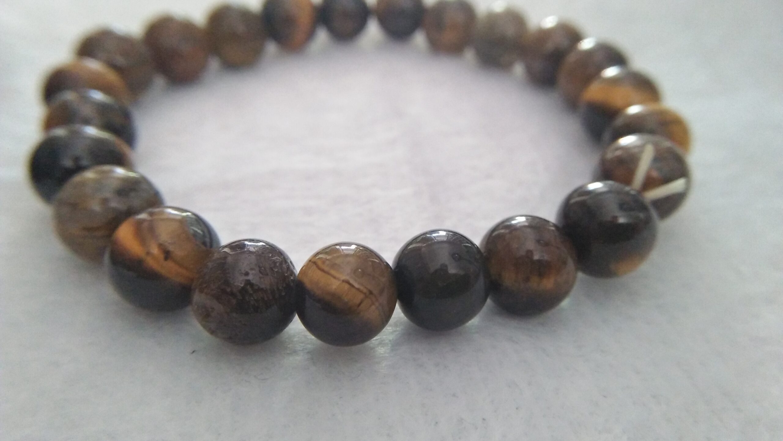 Tiger Eye Bracelet  Stone : Natural Tiger Eye Shape : Round Size : 8.8mm / 10.3mm / 12mm Treatment : Unheated / Natural Design : Gent / Ladies Both