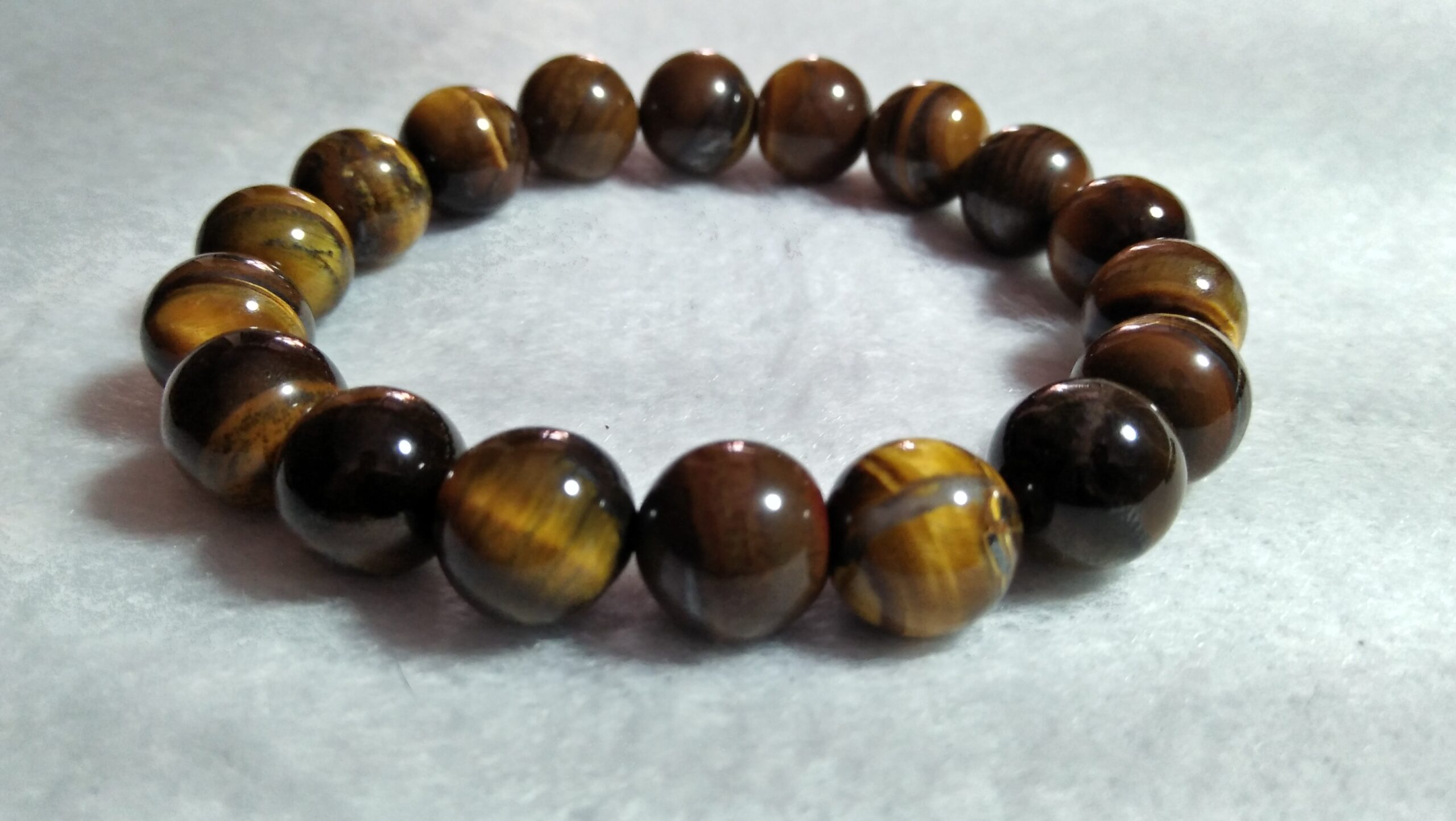 Tiger Eye Bracelet  Stone : Natural Tiger Eye Shape : Round Size : 8.8mm / 10.3mm / 12mm Treatment : Unheated / Natural Design : Gent / Ladies Both