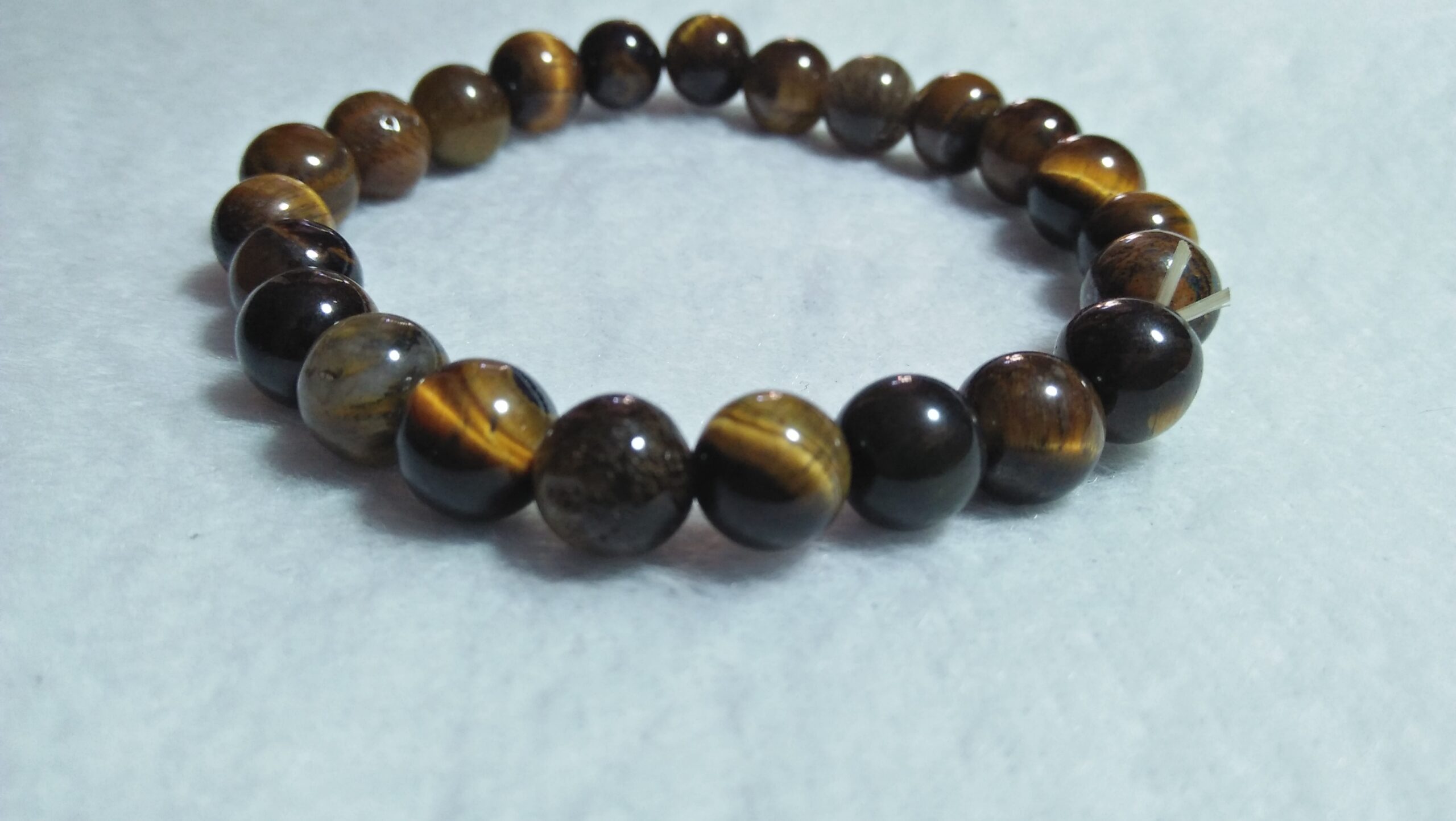 Tiger Eye Bracelet  Stone : Natural Tiger Eye Shape : Round Size : 8.8mm / 10.3mm / 12mm Treatment : Unheated / Natural Design : Gent / Ladies Both