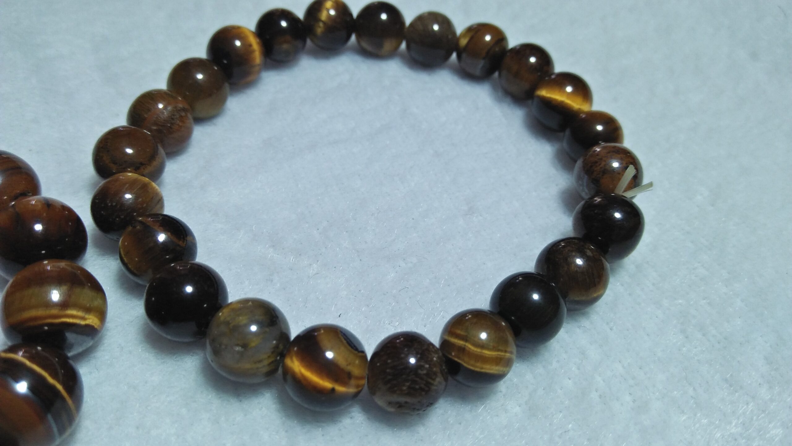 Tiger Eye Bracelet  Stone : Natural Tiger Eye Shape : Round Size : 8.8mm / 10.3mm / 12mm Treatment : Unheated / Natural Design : Gent / Ladies Both