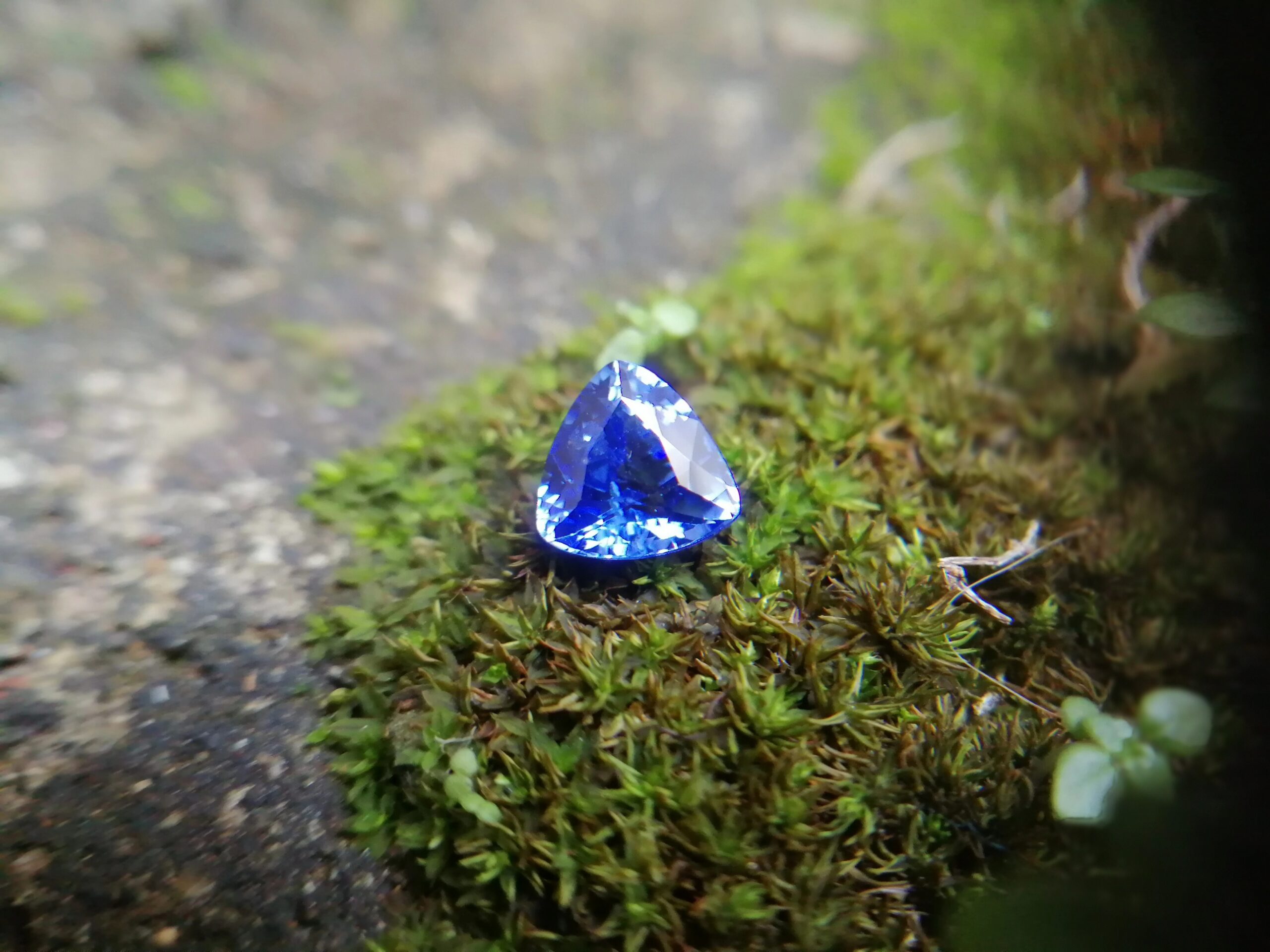 NATURAL BLUE SAPPHIRE "Cornflower Blue" Colour : Blue "Cornflower Blue" Shape : Trilian Treatment : Heated Clarity : SI • CSL - Colored Stone Laboratory Certified ( GIA Alumina Association Member ) We hide certificates of sold out product Sapphire is a precious gemstone, a variety of the mineral corundum, consisting of aluminum oxide with trace amounts of elements such as iron, titanium, chromium, copper, or magnesium. Sapphire deposits are found in Eastern Australia, Thailand, Sri Lanka, China, Vietnam, Madagascar, Greenland, East Africa, and in North America in mostly in Montana. Madagascar, Sri Lanka, and Kashmir produce large quantities of fine quality Sapphires for the world market. Sapphires are mined from alluvial deposits or from primary underground workings. Blue Sapphire and Ruby are the most popular Gemstone in Corundum Family. also, Orangy Pink Sapphire is called Padparadscha. The name Drive's from the Sinhalese word "padmaraga" " පද්මරාග", meaning lotus blossom, as the stone is of a similar color to the lotus blossom. Bi-Color Sapphire from DanuGroup Collection Also, Sapphire can be found as parti-color, bi-color or fancy color. Australia is a main parti-color Sapphire producer. White Sapphire also, White sapphire is a very popular stone to wear instead of Diamond as a 3rd hardness gemstone after diamond ( moissanite hardness is 9.5). Various colors of star sapphires A star sapphire is a type of sapphire that exhibits a star-like phenomenon known as asterism. Also, A rare variety of natural sapphire, known as color-change sapphire, exhibits different colors in a different light. Sapphires can be treated by several methods to enhance and improve their clarity and color. A common method is done by heating the sapphires in furnaces to temperatures between 500 and 1,850 °C for several hours, or by heating in a nitrogen-deficient atmosphere oven for 1 week or more. Geuda is a form of the mineral corundum. Geuda is found primarily in Sri Lanka. It's a semitransparent and milky appearance due to rutile inclusions. Geuda is used to improve its color by heat treatment. Some geuda varieties turn to a blue color after heat treatments and some turn to red after oxidizing. Also, Kowangu pushparaga turns to yellow sapphire after oxidizing. Sapphire Crystal system is a Trigonal crystal system with a hexagonal scalenohedral crystal class. Sapphire hardness is 9 according to the Mohs hardness scale with 4.0~4.1 specific gravity. Refractive index ω =1.768–1.772 nε =1.760–1.763 Solubility = Insoluble Melting point = 2,030–2,050 °C Birefringence = 0.008 Pleochroism = Strong Luster = Vitreous Sapphire is the birthstone for September and the gem of the 45th anniversary. Healing Properties of Sapphire Sapphire releases mental tension, depression, unwanted thoughts, and spiritual confusion. Sapphire is known as a "stone of Wisdom". It is exceptional for calming and focusing the mind, allowing the release of mental tension and unwanted thoughts. Sapphire is also the best stone for awakening chakras. Dark Blue or Indigo Sapphire stimulates the Third Eye chakra. Blue Sapphire stimulates the Throat Chakra. Green sapphire stimulates Heart Chakra. Black Sapphire stimulates Base Chakra. White sapphire stimulates Crown Chakra. Yellow sapphire stimulates Solar Plexus Chakra. Blue Sapphire stimulates the Throat Chakra and Third eye chakra, the voice of the body. Blue crystal energy will unblock and balance the Throat Chakra. blue encourages the power of truth, while lighter shades carry the power of flexibility, relaxation, and balance. Blue Sapphire can free one of mental anxiety, helps make one detached, and protects against envy. Also, It can be worn for good luck and for protection against evil spirits. Since Saturn rules the nervous system, blue sapphires help problems of the nerves-tension and neuroses-diseases caused by an afflicted Saturn.