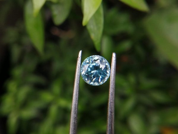 Colour: Light Green-Blue Shape: Round Weight : 2.31 Cts Dimension : 6.9 x 6.8 x 5.3 mm Locality: Cambodia Treatment: No identification of heat treatment on the Lab Report. but, Blue Zircon is Heated Clarity : VS • CSL - Colored Stone Laboratory Certified ( GIA Alumni Association Member ) • CSL Memo No: 82E5EB04FC43 Blue Zircon Stimulates Throat Chakra. It is a very popular gemstone in the new fashion world for brilliance pieces of jewelry. Zircon is a nesosilicates group mineral. Its corresponding chemical formula is ZrSiO4. The name derives from the Persian zargun, meaning "gold-hued". Zircon is a popular gemstone that has been used for nearly 2000 years. The crystal structure of zircon is a tetragonal crystal mineral with 7.5 hardness according to the Mohs Hardness scale. Zircon is also very resistant to heat and corrosion and known as Insoluble gemstone. This Uniaxial (+) mineral Specific gravity is 4.6–4.7. It's heavy more than such as Sapphire, chrysoberyl, Garnets, spinels. Gem Businessmen use these physical properties to identify zircons from other gemstones. Zircon has weak pleochroism and has colors such as Colorless, Very Strong Blue To Green-Blue, Yellow, Blue-Green, Yellowish Green, Yellow-Green, Brown, Orangy Yellow To Reddish Orange, Dark Brownish Red, Sometimes Purple, Gray To Bluish Gray, Brownish Gray. Colorless specimens that show gem quality are a popular substitute for diamond and are also known as "Matara diamond". Zircon has been classified into three types called high zircon, intermediate zircon ( medium zircon ), and low zircon. Some Quality Type brown zircons can be transformed into colorless and blue zircons by heating to 800 to 1000 °C. There are Some using names for Zircon such as Hyacinth or jacinth: yellow-red, orange, red-brown to brown, Jargoon or jargon: light yellow to colorless stones, Beccarite: green zircon, Melichrysos: straw yellow, Starlite: blue heat treated zircon, Sparklite: colorless zircon. Zircon is found in Madagascar, Sri Lanka, Tanzania, Cambodia, Australia, Burma, Afghanistan, Canada, USA, Thailand, Russia, Mozambique, Norway. Healing Properties 👇 Zircon is known as "The stone of virtue" All colors. It clears the auric negativity in the wearer and helps to communicate with the higher realm when in need. Zircon is very well known for its balancing and positive energy effects. It can attract happiness, prosperity, and abundance to the wearer. It will bring the spiritual energy down from the higher transpersonal chakras via the crown chakra, then move it to all of the lower chakras.