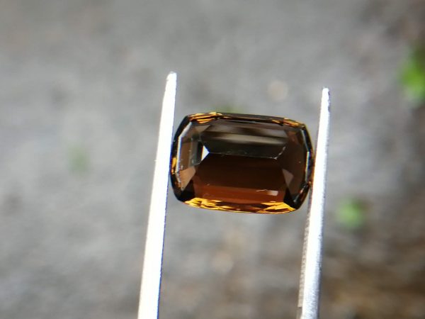 Colour : Brown Shape : Cushion Weight : 5.43 Cts Dimension : 12.4 x 8.5 x 6.3 mm Treatment : Unheated Clarity: VVS • CSL - Colored Stone Laboratory Certified ( GIA Alumina Association Member ) • CSL Memo No : 693F81AA1E41 Dravite Tourmaline Sri Lanka Dravite is the sodium magnesium rich Variety in the tourmaline family. Tourmaline is a crystalline boron silicate mineral compounded with elements such as aluminium, iron, magnesium, sodium, lithium, or potassium.                            The gemstone comes in a wide variety of colors such as black, brown, red, orange, yellow, green, blue, violet, pink, bi-colored, tri-colored and rarely can be neon green or electric blue.                               Tourmaline pleochroism is typically moderate to Strong. It is Cyclosilicate mineral with 7-7.5 hardness according to the more hardness scale and 3.06 (+.20 -.06) specific gravity. It is a Double refractive, uniaxial (-) mineral with the Trigonal crystal system. Tourmaline can be seen fluorescent inert to very weak red to violet in the long and short wave in pink Stones.                  Tourmaline can be found in India, Brazil, Tanzania, Nigeria, Kenya, Madagascar, Mozambique, Namibia, Afghanistan, Sri Lanka, USA, Ethiopia. Tourmaline Healing Properties              Tourmaline balances the right-left sides of the brain. It Helps treat paranoia, overcomes dyslexia. Also, It Improves circulation and supports the liver and kidneys.                            Tourmaline helps to eliminate toxic metals in the body and Reduces lactic acids and free fatty acids. It is a stone of purification, cleansing the emotional body of negative thoughts, anxieties, anger, and feelings of unworthiness.                         The brown tourmaline brings gentle and soothing healing of your emotional body. It is a very strong grounding stone that raises one’s stamina and protective energies. Brown tourmaline works specifically with the heart chakra to provide self-healing and rejuvenating energies.