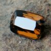Colour : Brown Shape : Cushion Weight : 5.43 Cts Dimension : 12.4 x 8.5 x 6.3 mm Treatment : Unheated Clarity: VVS • CSL - Colored Stone Laboratory Certified ( GIA Alumina Association Member ) • CSL Memo No : 693F81AA1E41 Dravite Tourmaline Sri Lanka Dravite is the sodium magnesium rich Variety in the tourmaline family. Tourmaline is a crystalline boron silicate mineral compounded with elements such as aluminium, iron, magnesium, sodium, lithium, or potassium.                            The gemstone comes in a wide variety of colors such as black, brown, red, orange, yellow, green, blue, violet, pink, bi-colored, tri-colored and rarely can be neon green or electric blue.                               Tourmaline pleochroism is typically moderate to Strong. It is Cyclosilicate mineral with 7-7.5 hardness according to the more hardness scale and 3.06 (+.20 -.06) specific gravity. It is a Double refractive, uniaxial (-) mineral with the Trigonal crystal system. Tourmaline can be seen fluorescent inert to very weak red to violet in the long and short wave in pink Stones.                  Tourmaline can be found in India, Brazil, Tanzania, Nigeria, Kenya, Madagascar, Mozambique, Namibia, Afghanistan, Sri Lanka, USA, Ethiopia. Tourmaline Healing Properties              Tourmaline balances the right-left sides of the brain. It Helps treat paranoia, overcomes dyslexia. Also, It Improves circulation and supports the liver and kidneys.                            Tourmaline helps to eliminate toxic metals in the body and Reduces lactic acids and free fatty acids. It is a stone of purification, cleansing the emotional body of negative thoughts, anxieties, anger, and feelings of unworthiness.                         The brown tourmaline brings gentle and soothing healing of your emotional body. It is a very strong grounding stone that raises one’s stamina and protective energies. Brown tourmaline works specifically with the heart chakra to provide self-healing and rejuvenating energies.