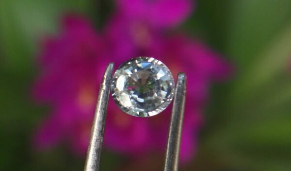Colour: White Shape: Oval Weight : 0.80 Cts Dimension : 5.9 x 5.1 x 3.1 mm Treatment: Heated Clarity: I Sapphire is a precious gemstone, a variety of the mineral corundum, consisting of aluminum oxide with trace amounts of elements such as iron, titanium, chromium, copper, or magnesium. Sapphire deposits are found in Eastern Australia, Thailand, Sri Lanka, China, Vietnam, Madagascar, Greenland, East Africa, and in North America in mostly in Montana. Madagascar, Sri Lanka, and Kashmir produce large quantities of fine quality Sapphires for the world market. Sapphires are mined from alluvial deposits or from primary underground workings.   Blue Sapphire and Ruby are the most popular Gemstone in Corundum Family. also, Orangy Pink Sapphire is called Padparadscha. The name Drive's from the Sinhalese word "padmaraga" " පද්මරාග", meaning lotus blossom, as the stone is of a similar color to the lotus blossom. Bi-Color Sapphire from DanuGroup Collection Also, Sapphire can be found as parti-color, bi-color or fancy color. Australia is a main parti-color Sapphire producer. White Sapphire also, White sapphire is a very popular stone to wear instead of Diamond as a 3rd hardness gemstone after diamond ( moissanite hardness is 9.5). Various colors of star sapphires A star sapphire is a type of sapphire that exhibits a star-like phenomenon known as asterism. Also, A rare variety of natural sapphire, known as color-change sapphire, exhibits different colors in a different light. Sapphires can be treated by several methods to enhance and improve their clarity and color. A common method is done by heating the sapphires in furnaces to temperatures between 500 and 1,850 °C for several hours, or by heating in a nitrogen-deficient atmosphere oven for 1 week or more. Geuda is a form of the mineral corundum. Geuda is found primarily in Sri Lanka. It's a semitransparent and milky appearance due to rutile inclusions. Geuda is used to improve its color by heat treatment. Some geuda varieties turn to a blue color after heat treatments and some turn to red after oxidizing. Also, Kowangu pushparaga turns to yellow sapphire after oxidizing. Sapphire Crystal system is a Trigonal crystal system with a hexagonal scalenohedral crystal class. Sapphire hardness is 9 according to the Mohs hardness scale with 4.0~4.1 specific gravity. Refractive index ω          =1.768–1.772 nε =1.760–1.763 Solubility = Insoluble Melting point = 2,030–2,050 °C Birefringence  = 0.008 Pleochroism = Strong Luster = Vitreous Sapphire is the birthstone for September and the gem of the 45th anniversary. Healing Properties of Sapphire Sapphire releases mental tension, depression, unwanted thoughts, and spiritual confusion.  Sapphire is known as a "stone of Wisdom". It is exceptional for calming and focusing the mind, allowing the release of mental tension and unwanted thoughts. Sapphire is also the best stone for awakening chakras. Dark Blue or Indigo Sapphire stimulates the Third Eye chakra. Blue Sapphire stimulates the Throat Chakra. Green sapphire stimulates Heart Chakra. Black Sapphire stimulates Base Chakra. White sapphire stimulates Crown Chakra. Yellow sapphire stimulates Solar Plexus Chakra. White Sapphire brings wisdom and strength of spirit. It stimulates the pineal and pituitary glands and also beneficial in gathering courage. White Sapphire stimulates the Crown Chakra. It helps to balance crown chakra to balance your energies. When crown chakra balance, energies are balance. As a pure Aluminium Oxide crytal, White Sapphire clears the mind during meditation. Its vibrant energies help to reduce stress and keep calm your mind during meditation.