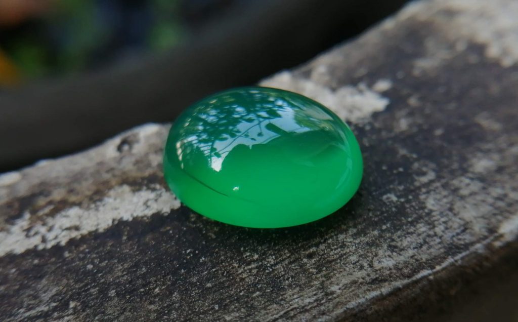 Natural Green Onyx Colour: Green Shape: Oval Cut: Cabochon Weight : 7.00 Cts Dimension : 13.9 x 11.1 x 6.5 mm Treatment: Unheated Clarity: Translucent Green Onyx is a member of the Quartz Family that has different colors and various properties and characteristics. It's A variety of Agate. Agate and onyx are both varieties of layered chalcedony that differ only in the form of the bands: agate has curved bands and onyx has parallel bands. Green Onyx can be found in Afghanistan, Australia, China, Canada, France, Germany, UK, India, Madagascar, USA. • Crystal system: Trigonal • Chemical formula: SiO₂ • Hardness (Mohs hardness scale): 6.5 - 7 • Mineral class: Chalcedony • Transparency: Translucent, Opaque • Specific gravity: 2.6–2.65 • Optical properties: Uniaxial/+ • Refractive index: 1.530 to 1.543 Main Healing Properties This Silicate mineral vibrational energy help to reduce tension, stress, and fears. also, It's green color energy increases attraction and stimulates heart chakra energies. also, Green Onyx balances blood circulations all of the body as well as Carnelian increases blood circulation. Healing Properties Green Onyx is associated with Heart Chakra and the planet Mercury. It helps to develop your public speaking ability, creativeness and also encourage you to express your feelings and thoughts. This stone creates a bridge between the upper three chakras and the lower three chakras. This green soothing stone has the power to reduce you all worries, tension, stress, and fears