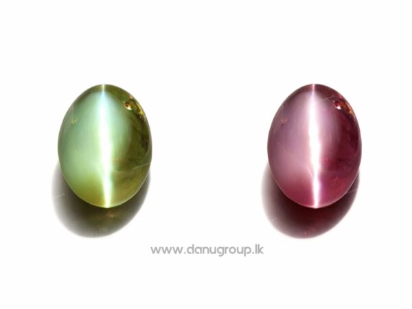 Natural red Alexandrite Cat’s Eye with strong cat’s eye band on dark textured background.