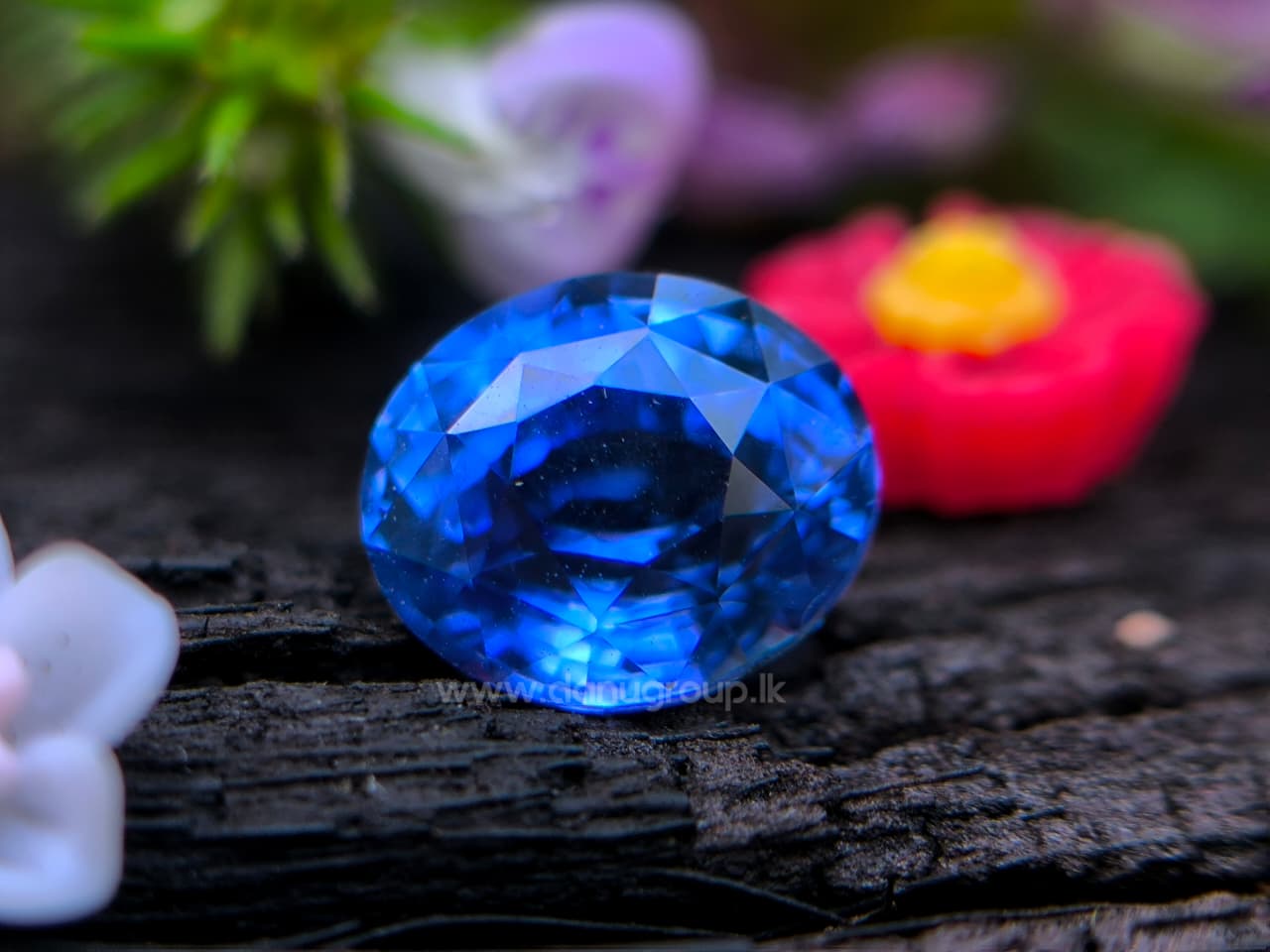 Natural 1.19 ct blue sapphire photographed on a natural background